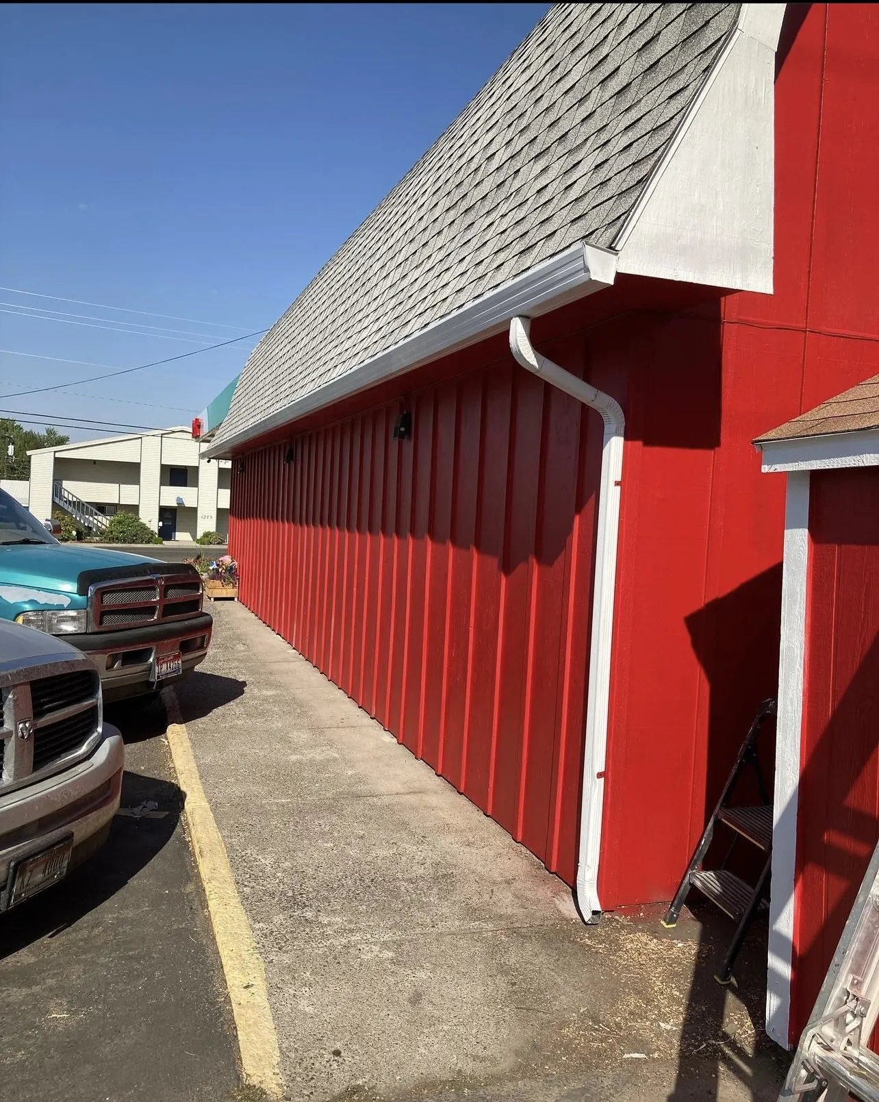 Red board-and-batten siding on a commercial barn building after painting, Star, Idaho area