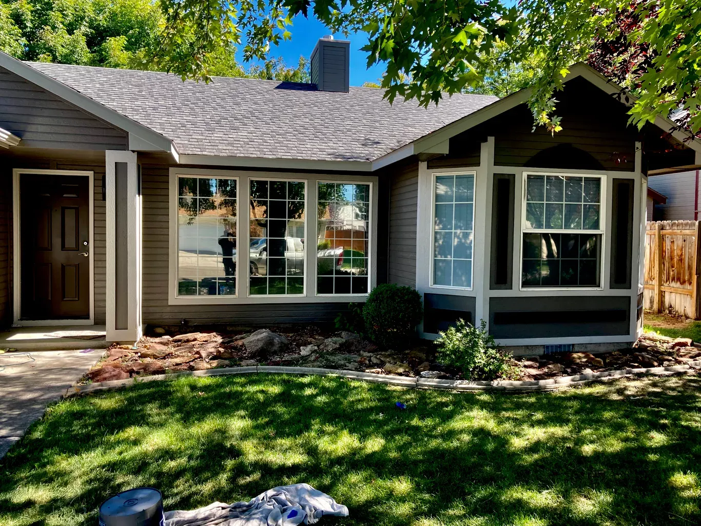 After: front of house with gray siding and white window trim after exterior painting in Star, Idaho