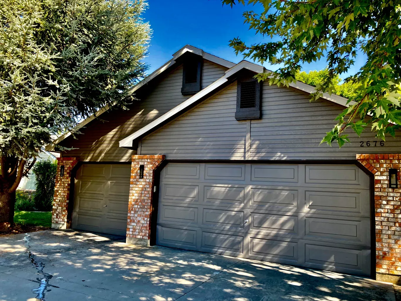 After: house and garage painted gray with white trim by Glenn Painting Co. in Star, Idaho