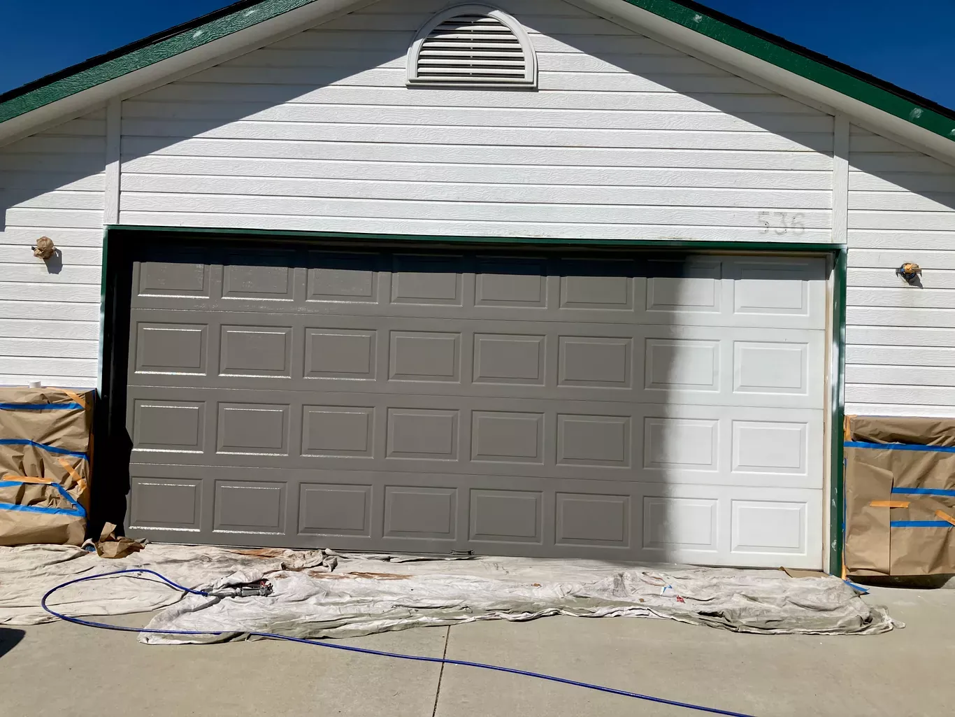 Garage door painting in progress by Glenn Painting Co