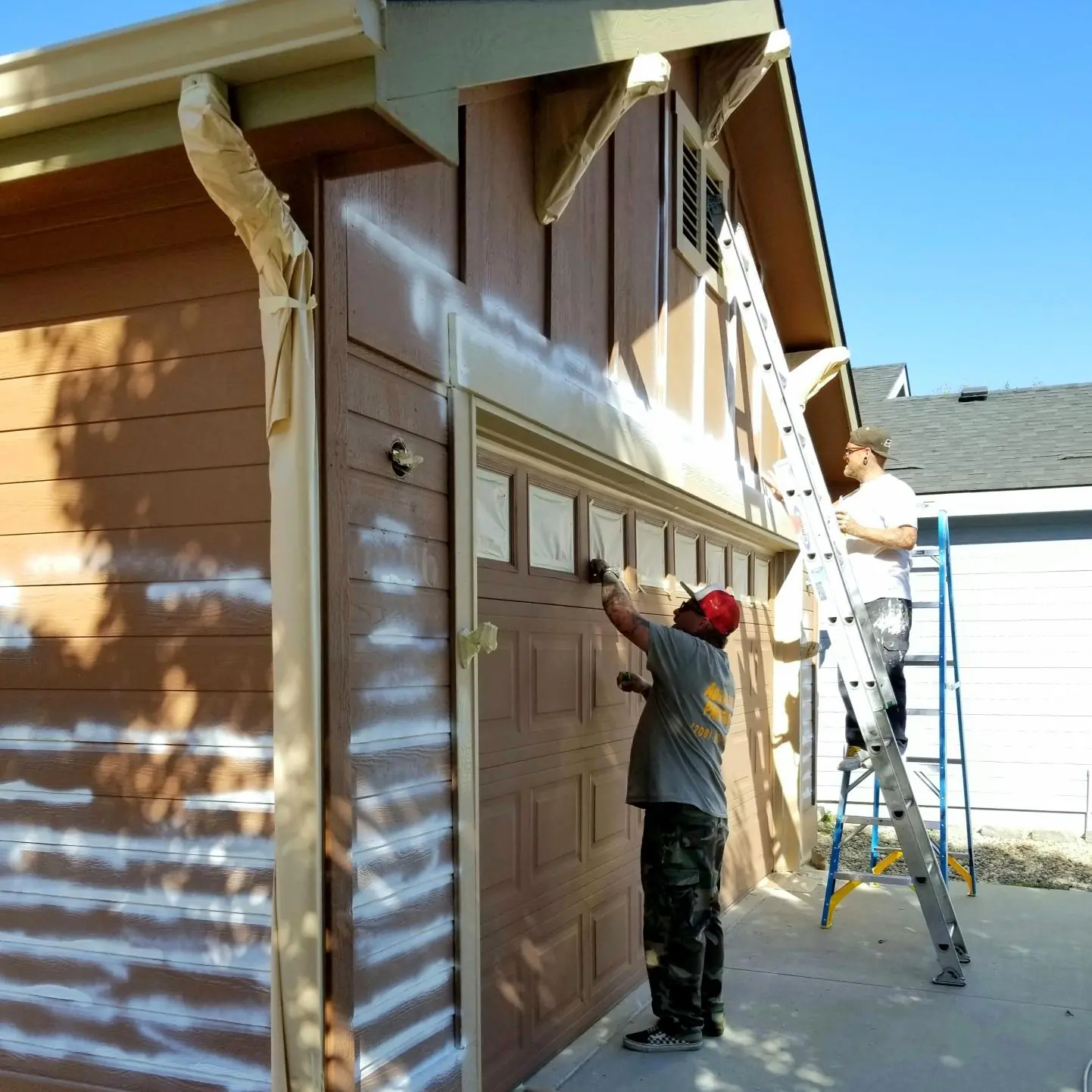 Garage exterior prep spraying by Glenn Painting Co