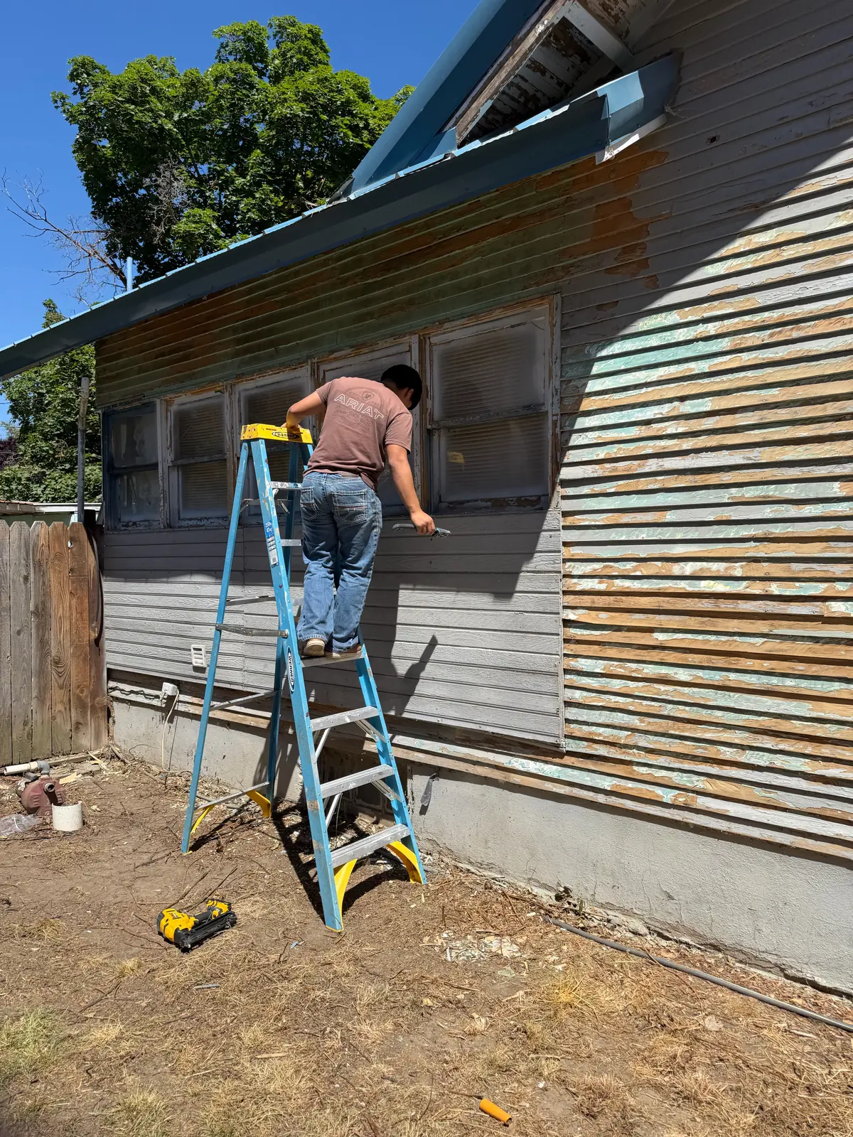 Bungalow repaint prep scraping in Weiser, ID by Glenn Painting Co