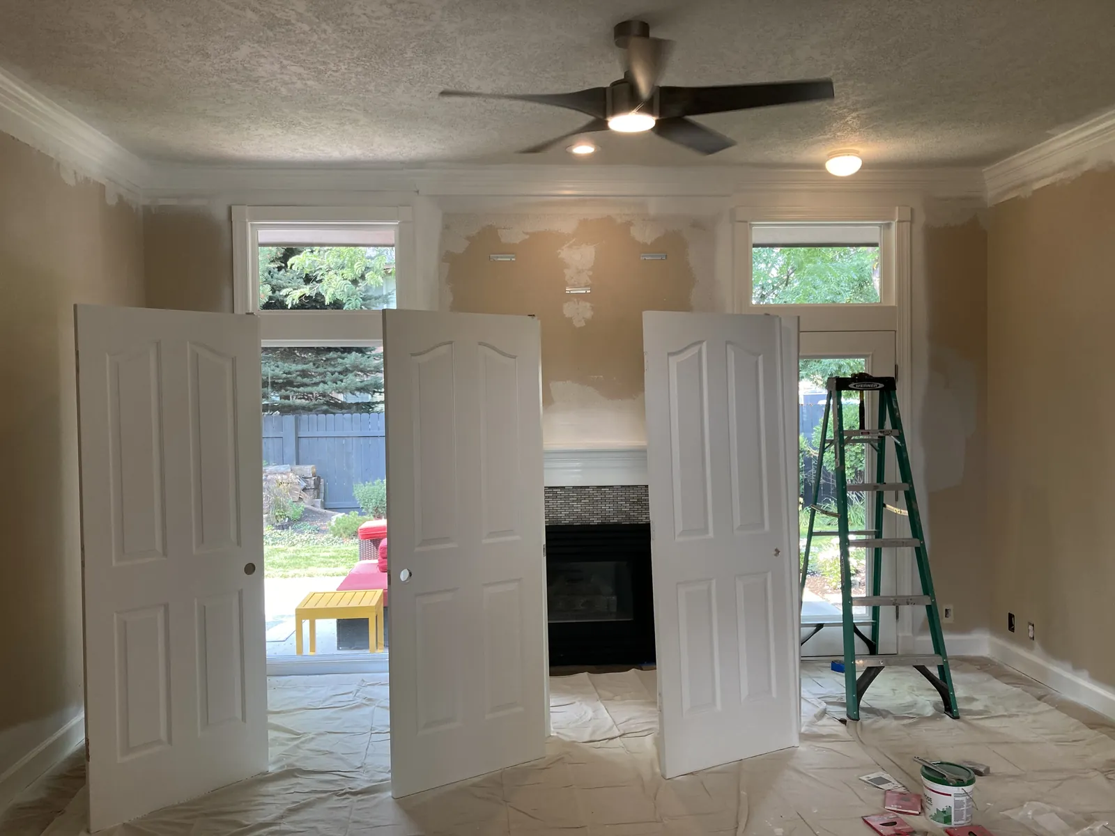 Living room with French doors and fireplace masked and prepped for interior painting, Treasure Valley